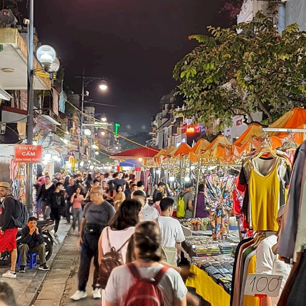 Visitors strolling through Hanoi’s vibrant streets at night